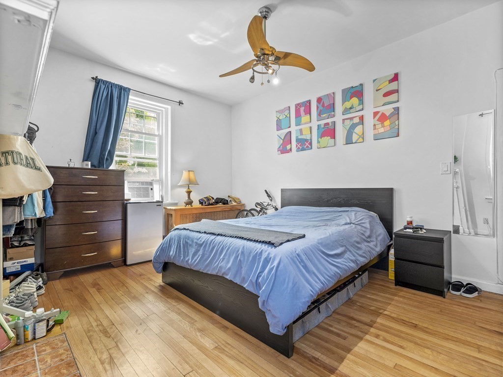 5 Spofford Road, Unit 8 Boston, MA 02134 - Photo 11 of 20 a bedroom with a bed and a chandelier