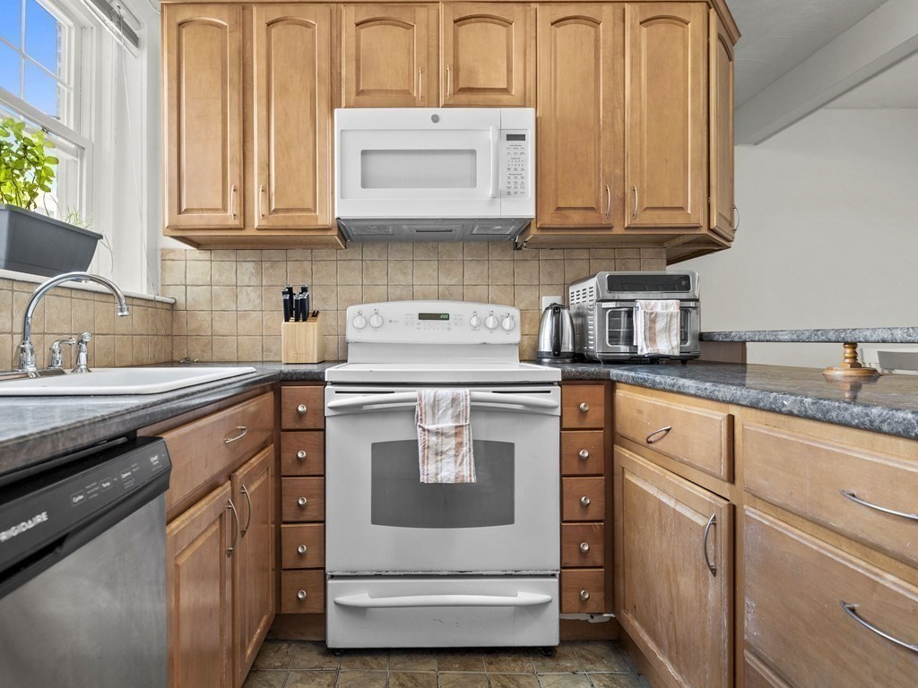 5 Spofford Road, Unit 8 Boston, MA 02134 - Photo 5 of 20 a kitchen with granite countertop white cabinets stainless steel appliances and a sink