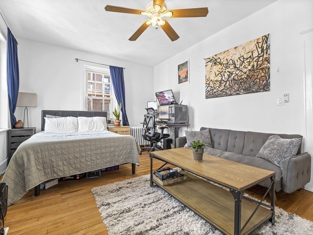 5 Spofford Road, Unit 8 Boston, MA 02134 - Photo 9 of 20 a bedroom with a bed a couch and a window