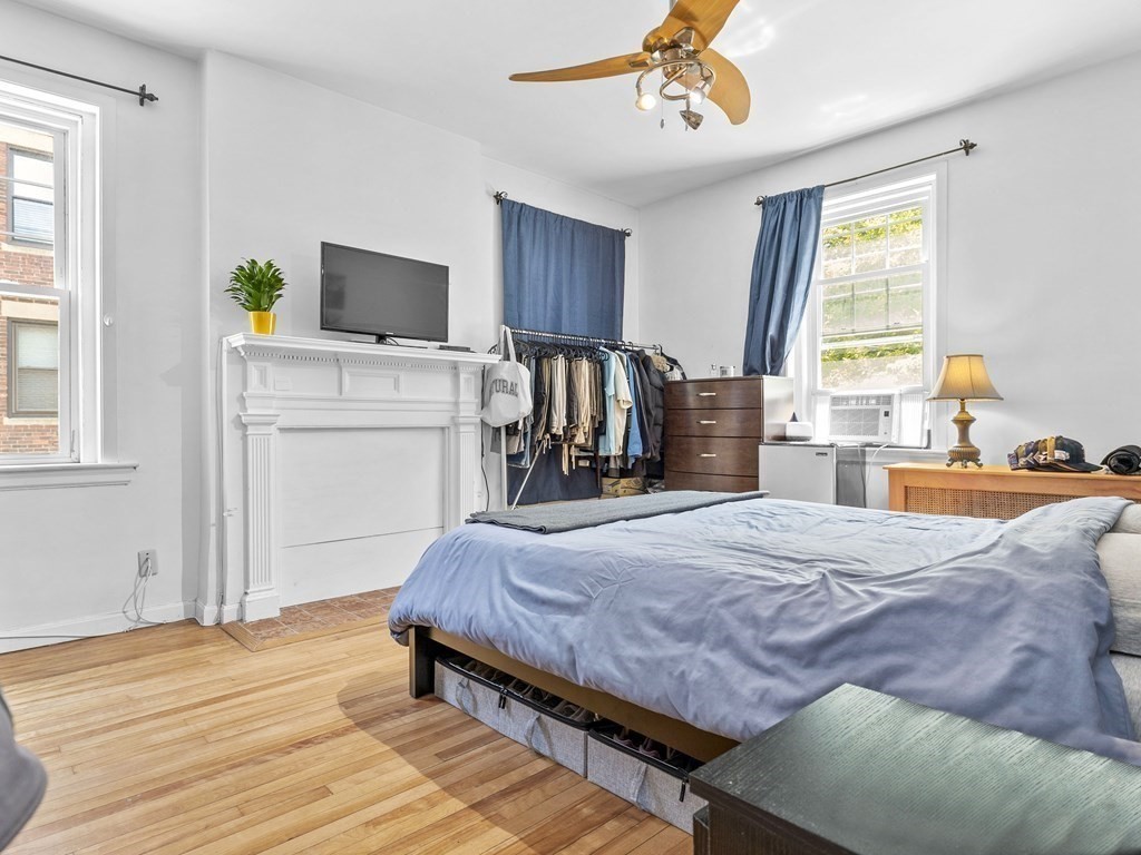 5 Spofford Road, Unit 8 Boston, MA 02134 - Photo 10 of 20 a bedroom with a bed and wooden floor