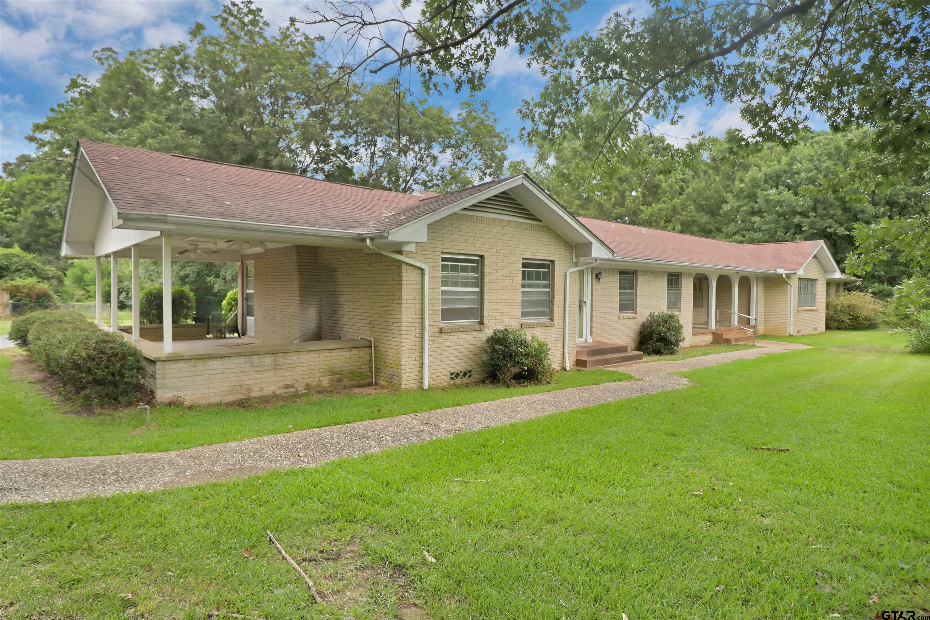 a front view of a house with a yard and porch