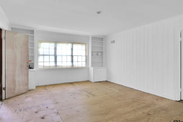 an empty room with a empty space and windows