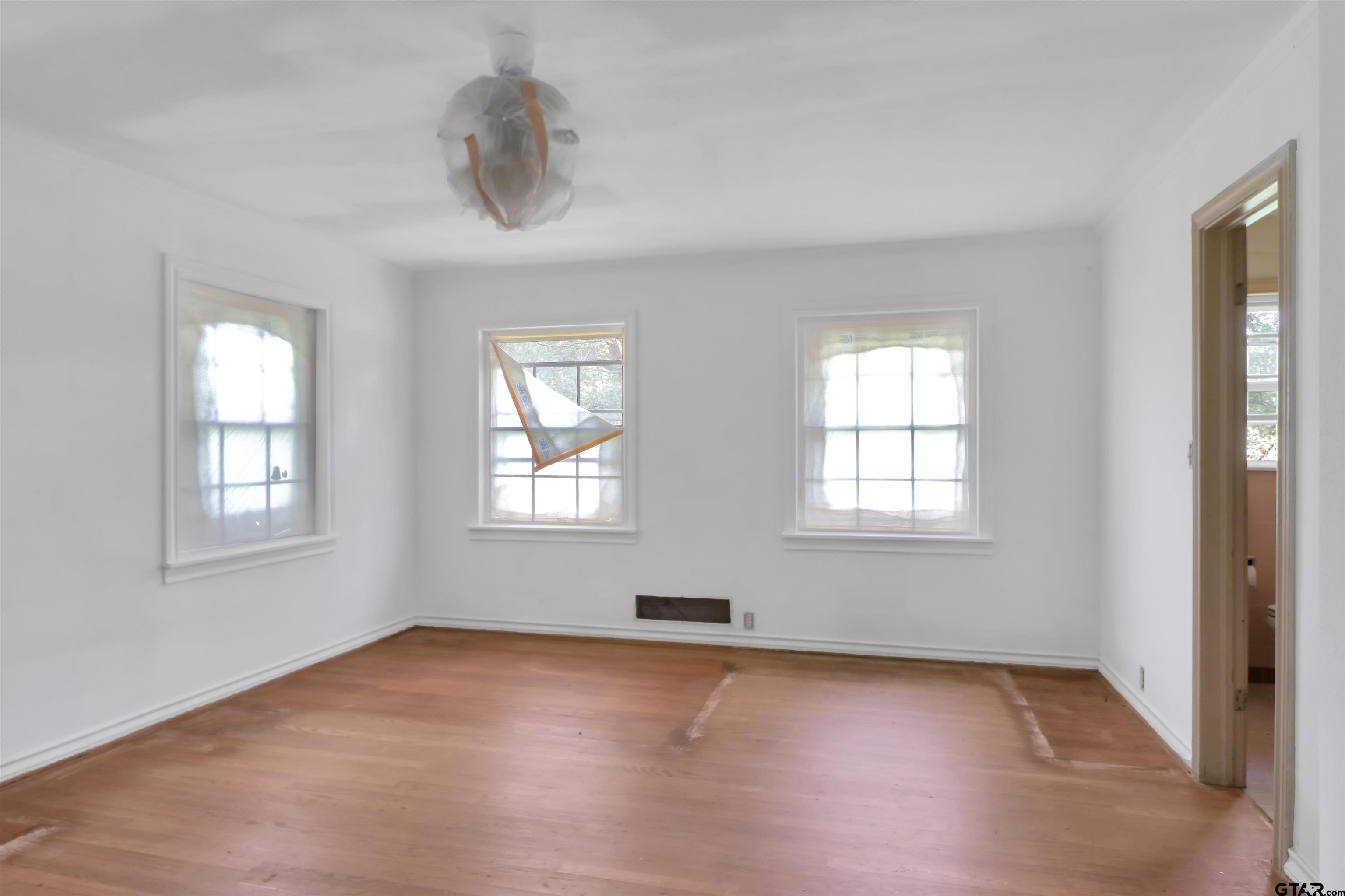 17645 East Us Highway Rusk, TX 75785 - Photo 19 of 31 an empty room with wooden floor chandelier and windows