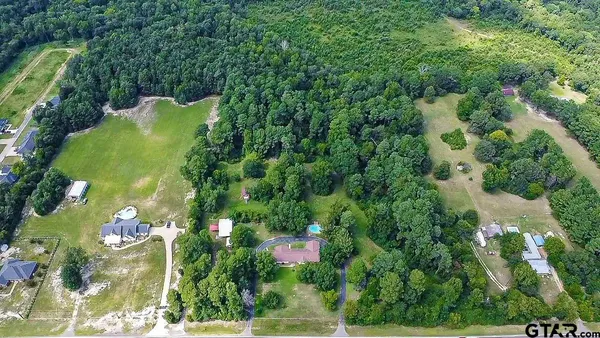a view of a balcony with yard