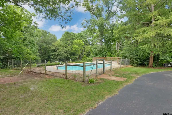 a front view of a house with a garden and yard