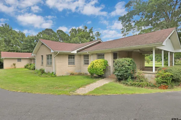 a view of a house with garden and deck