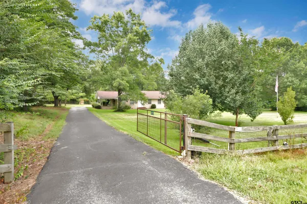 an empty room with windows and fireplace