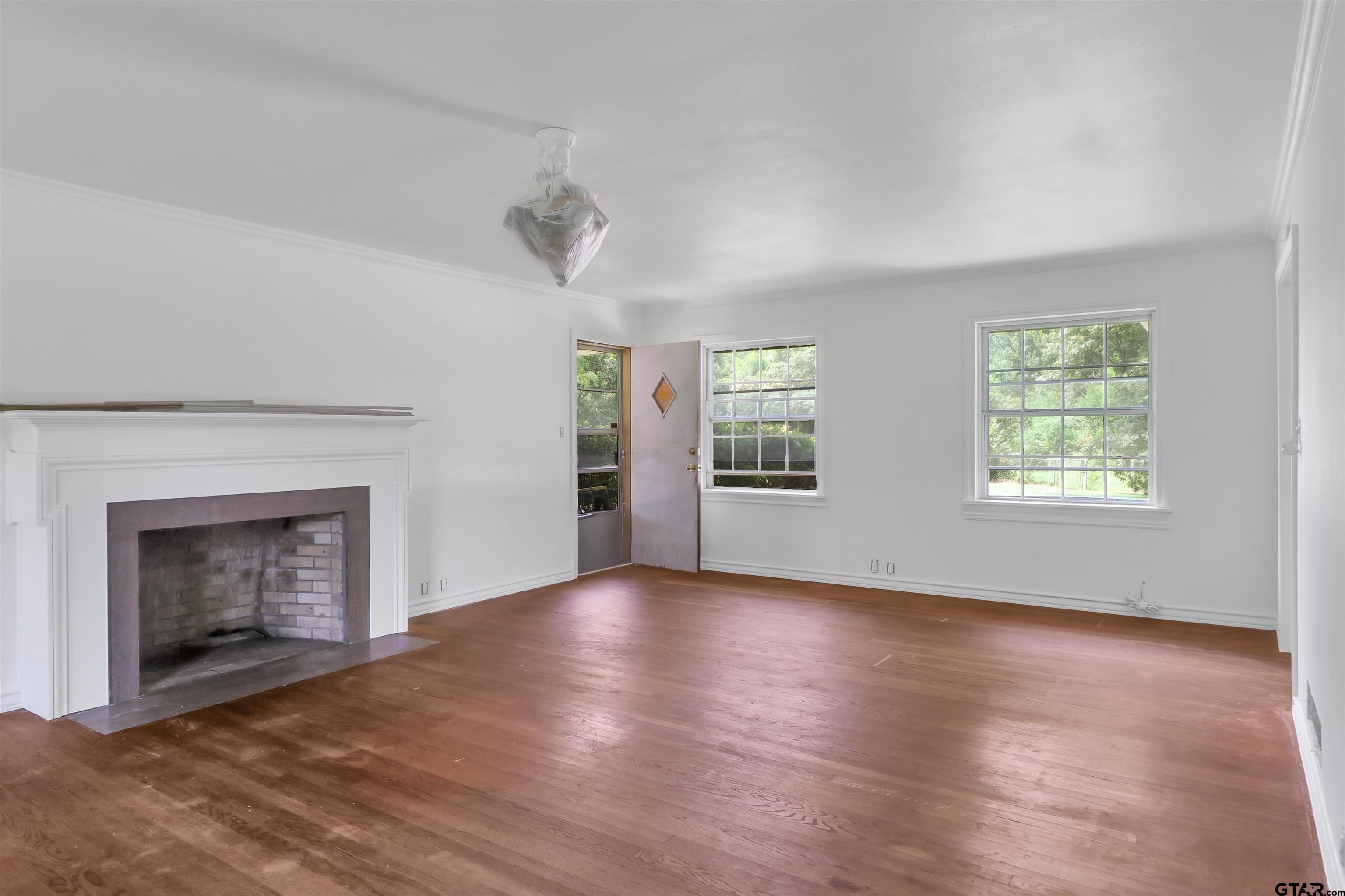 17645 East Us Highway Rusk, TX 75785 - Photo 7 of 31 wooden floor fireplace and windows in an empty room