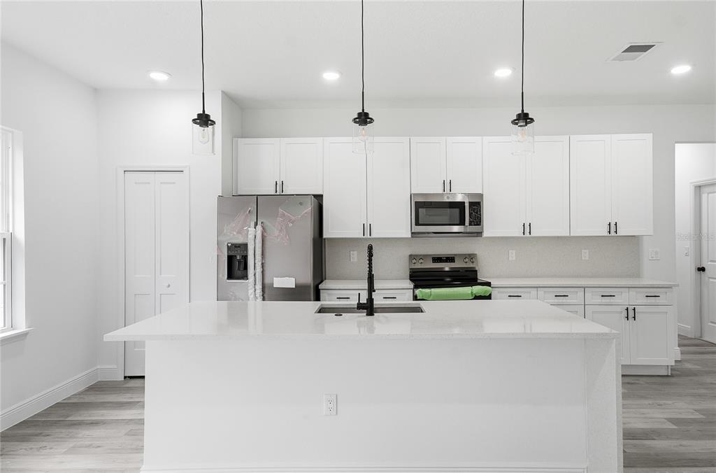 2773 Southwest 147st Street Road Ocala, FL 34473 - Photo 13 of 35 a kitchen with stainless steel appliances a refrigerator sink and microwave