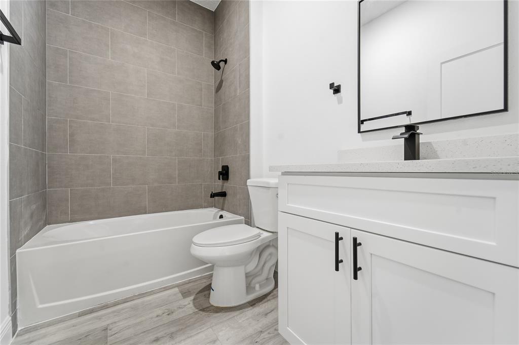 2773 Southwest 147st Street Road Ocala, FL 34473 - Photo 21 of 35 a bathroom with a toilet a sink and bathtub