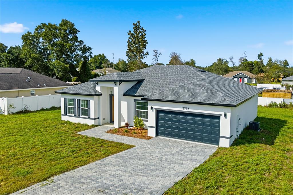 2773 Southwest 147st Street Road Ocala, FL 34473 - Photo 32 of 35 a front view of a house with garden