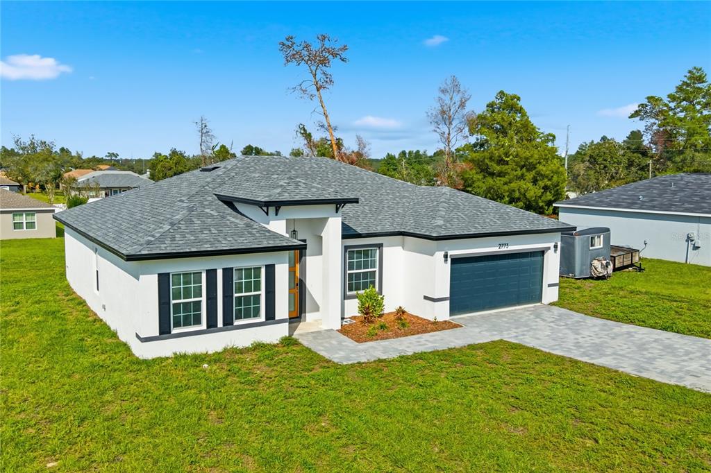 2773 Southwest 147st Street Road Ocala, FL 34473 - Photo 33 of 35 a view of a house with a yard and potted plants