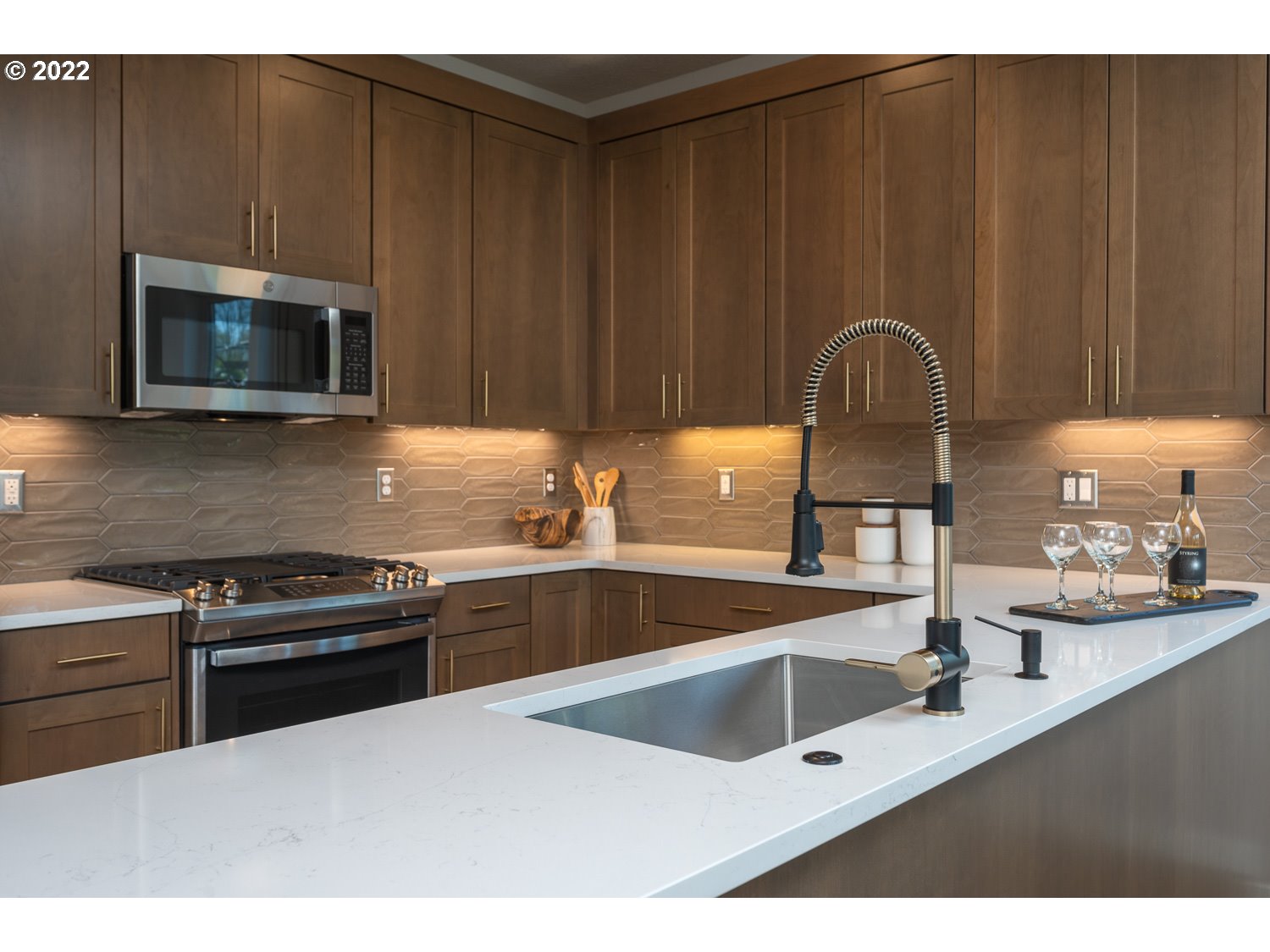 1175 Southeast Grant Street Portland, OR 97214 - Photo 11 of 32 a kitchen with granite countertop a stove a sink and a microwave