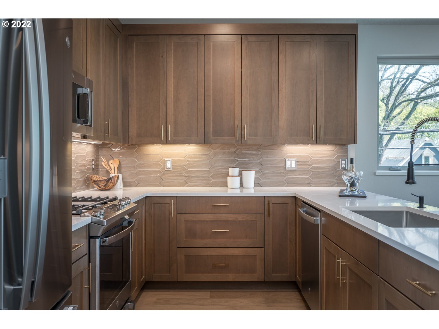 1175 Southeast Grant Street Portland, OR 97214 - Photo 12 of 32 a kitchen with a sink a stove and cabinets