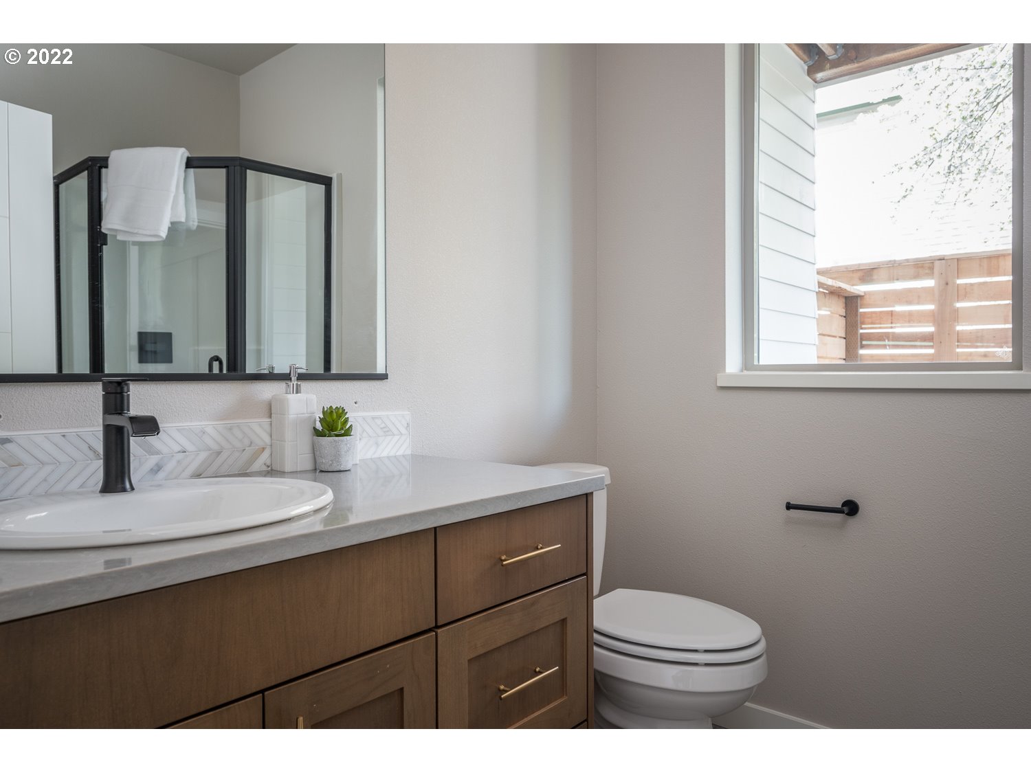 1175 Southeast Grant Street Portland, OR 97214 - Photo 25 of 32 a bathroom with a sink a toilet and mirror