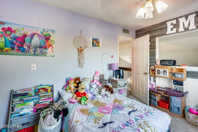 a bedroom with a bed and a chandelier