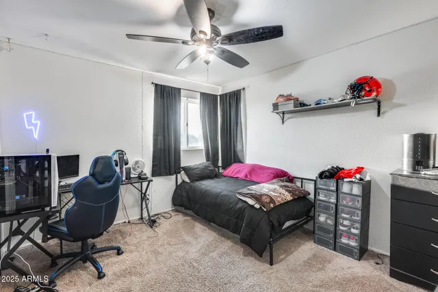 a spacious bedroom with a bed a couch and dresser