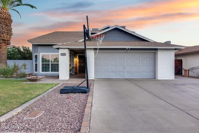 a view of a house with a yard and garage