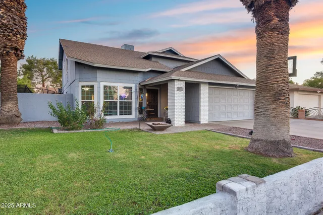 a front view of a house with a yard and garage