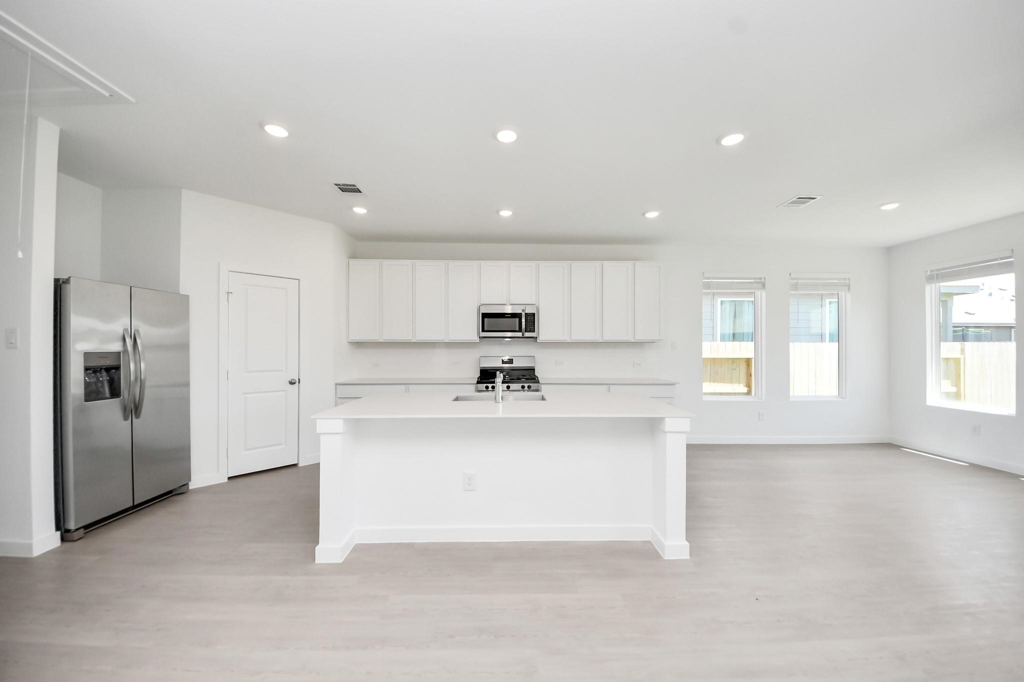 10650 Ellerston Road Cleveland, TX 77327 - Photo 7 of 25 Equipped with stainless steel appliances and large island with spaces for bar stools