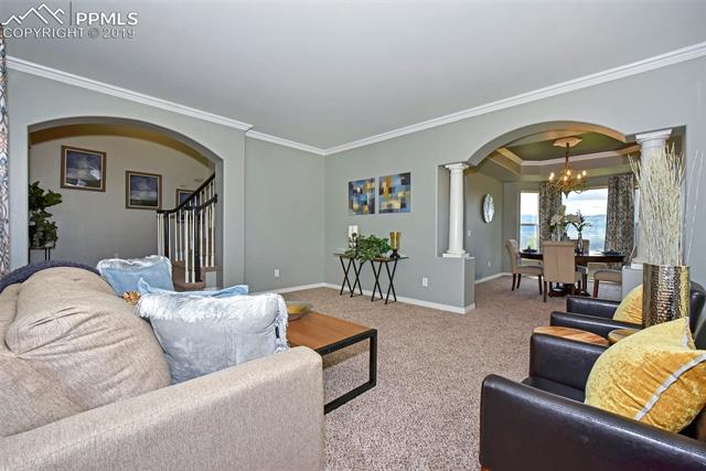 15190 Ridgefield Lane Colorado Springs, CO 80921 - Photo 4 of 31 Roomy front formal living room w/arched entries and crown molding!