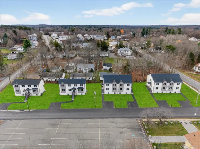 an aerial view of a house with a garden and trees