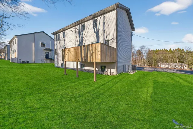 a backyard of a house with table and chairs