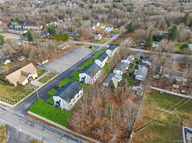 an aerial view of a house a yard swimming pool and outdoor seating