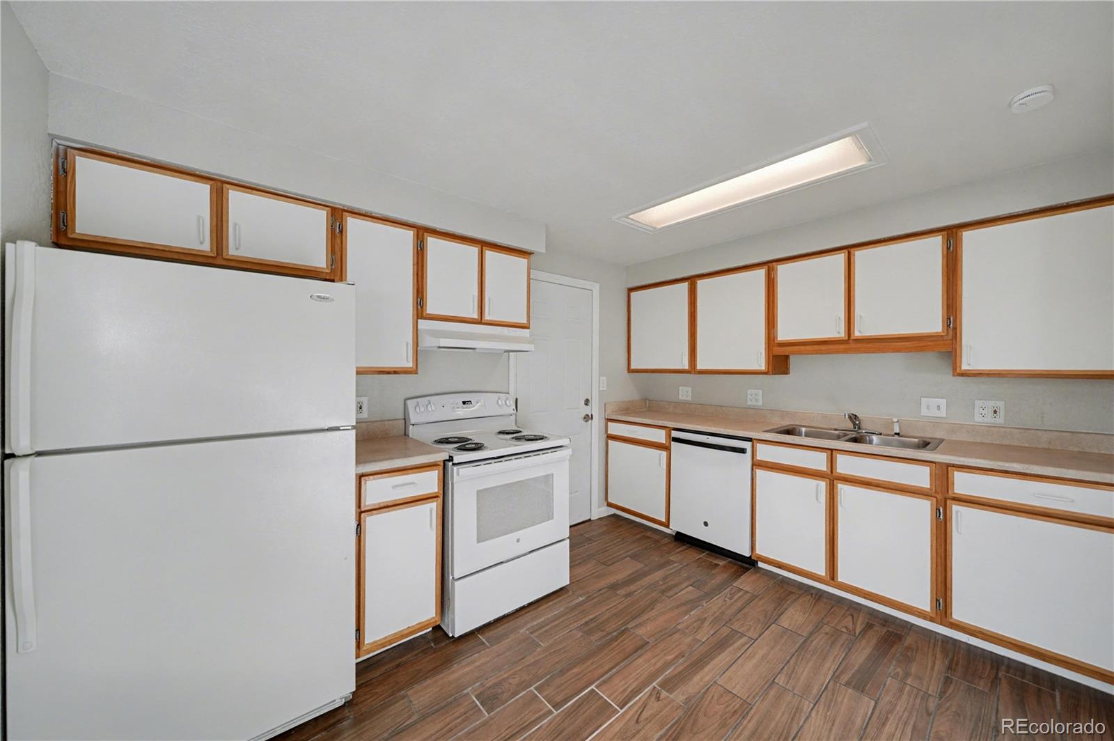 741 Emporia Street, Unit 741 Aurora, CO 80010 - Photo 3 of 11 a kitchen with stainless steel appliances granite countertop a refrigerator a stove a sink and a microwave