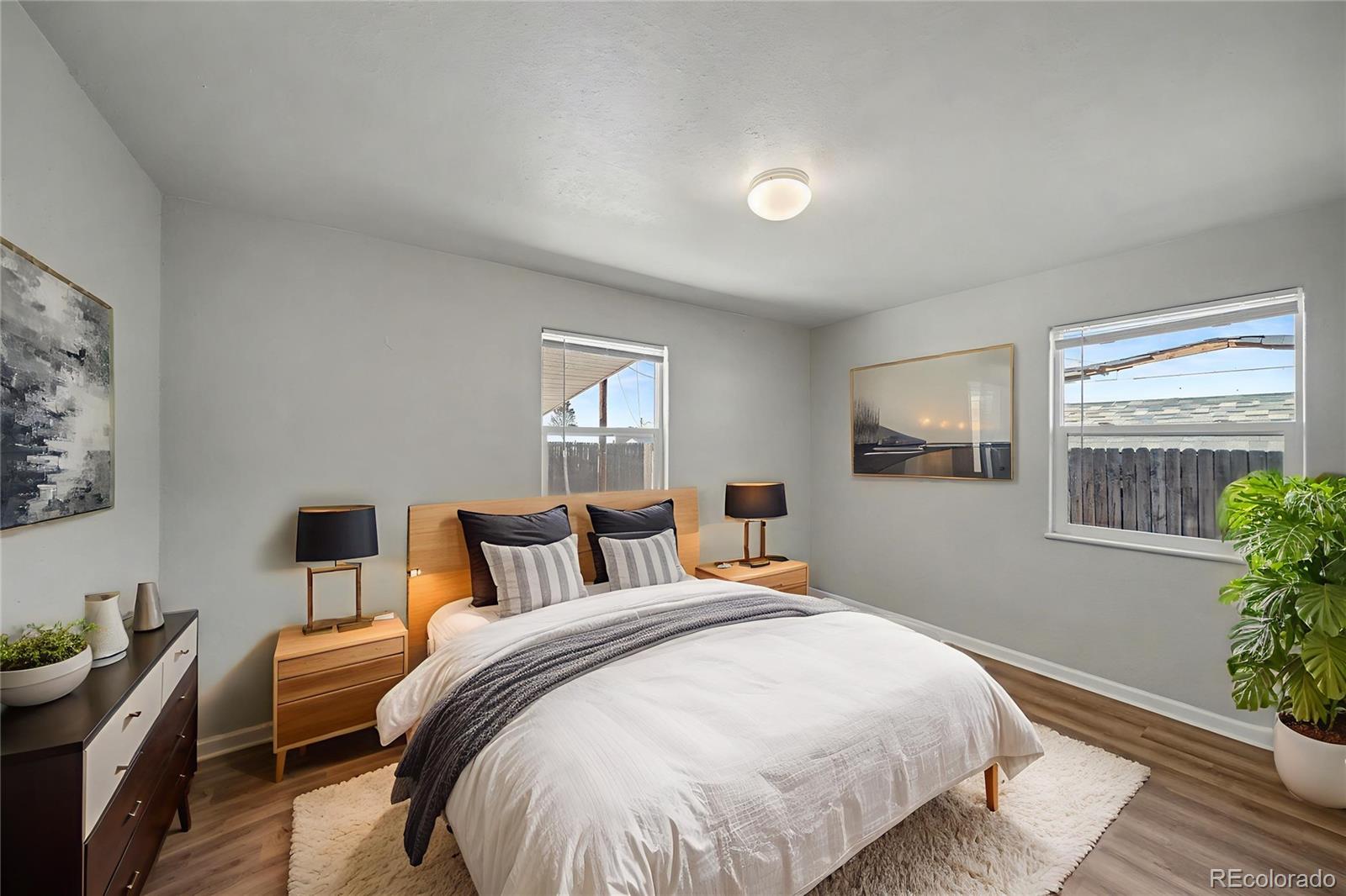741 Emporia Street, Unit 741 Aurora, CO 80010 - Photo 4 of 11 a bedroom with a bed and wooden floor