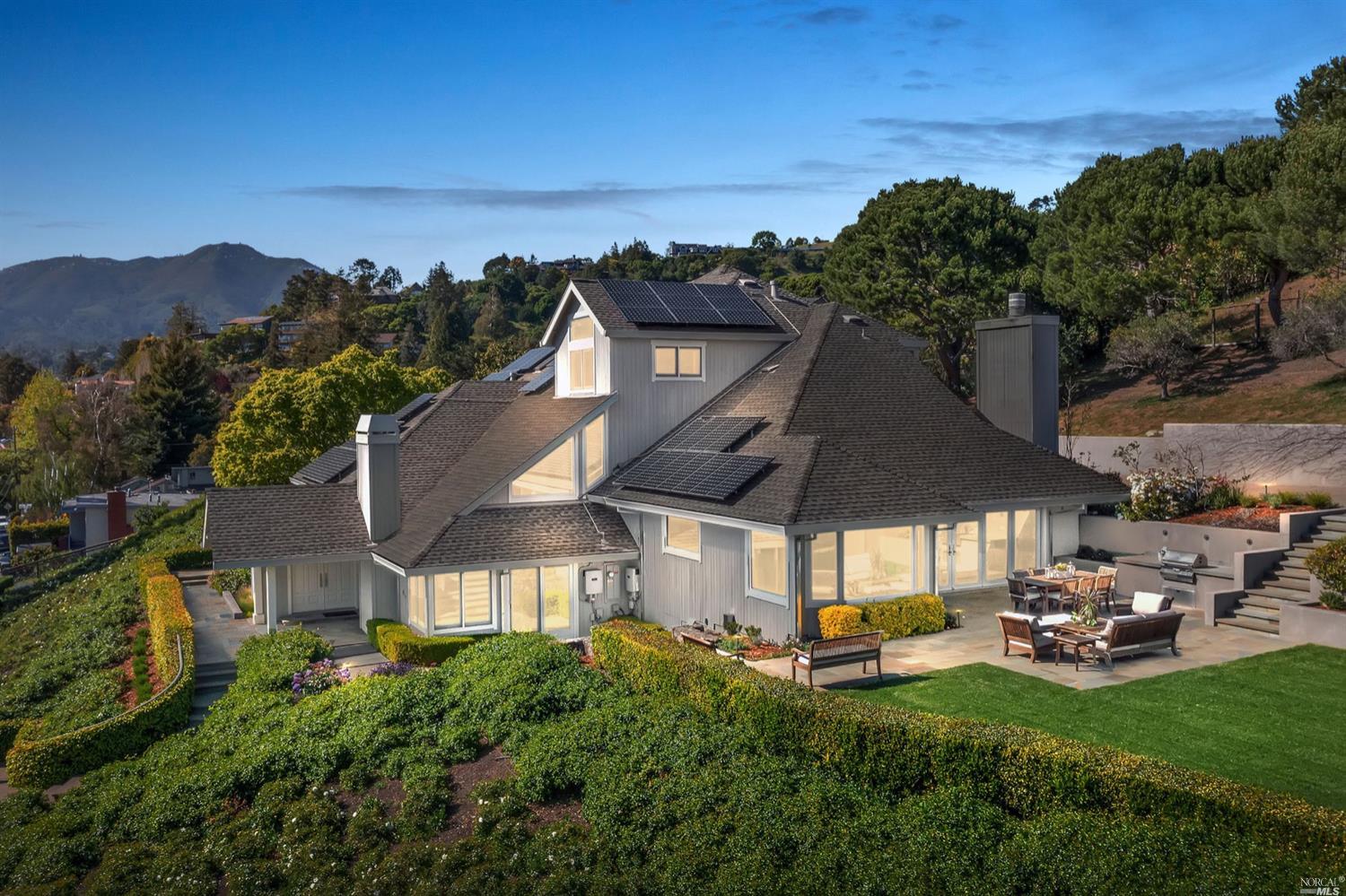 25 Altamont Avenue Mill Valley, CA 94941 - Photo 1 of 1 a view of a patio with table and chairs under an umbrella
