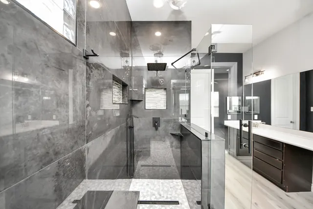 a large kitchen with a large counter top appliances and cabinets