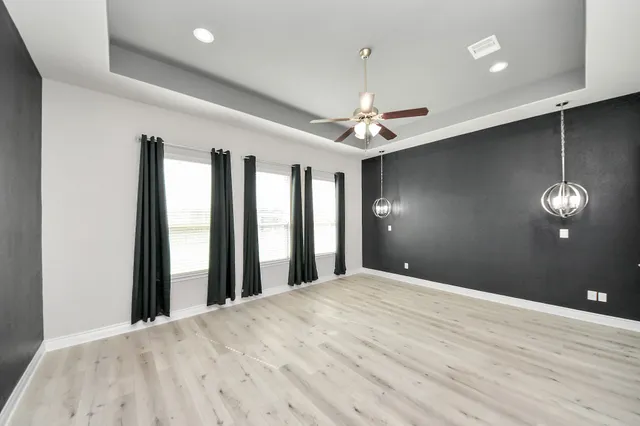 a bedroom with a large bed and a chandelier