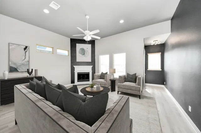 a living room with furniture fireplace and a chandelier