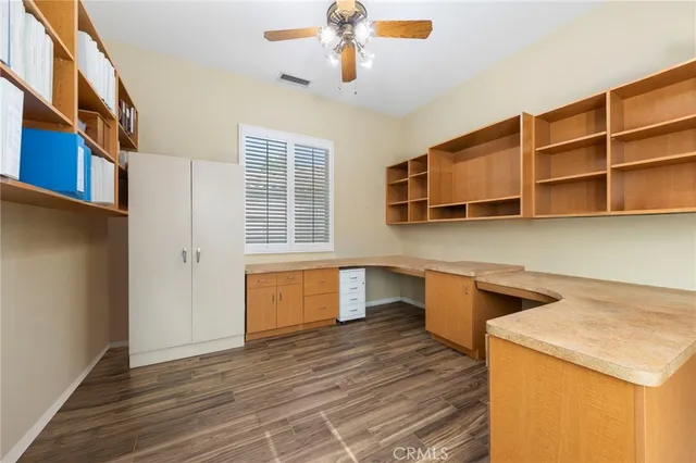 a kitchen with a wooden floor and window
