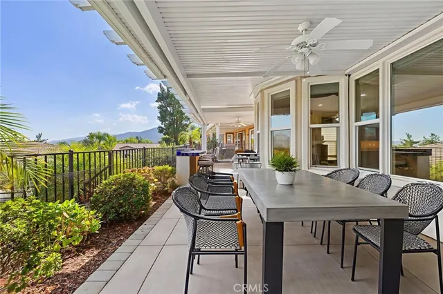 a view of a balcony with chairs and wooden floor