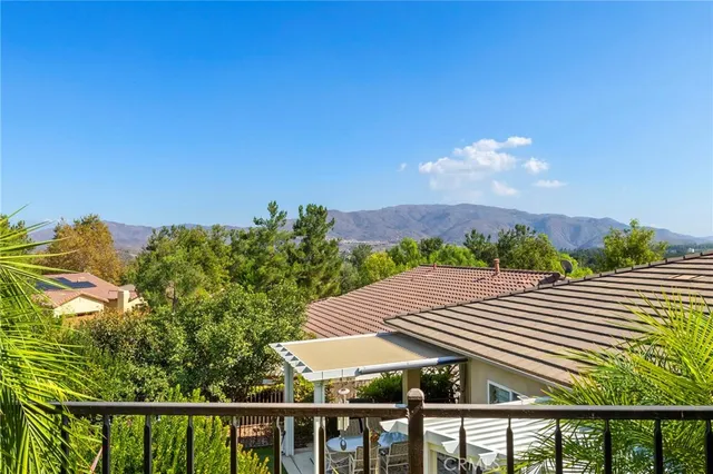 a view of a balcony with a yard