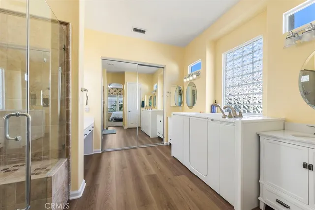 a bathroom with a double vanity sink and a mirror
