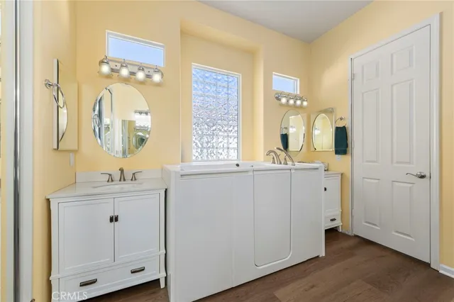 a bathroom with a double vanity sink mirror and