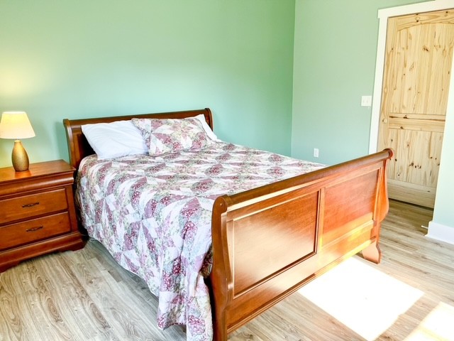 3576 Dog Branch Road Prospect, TN 38477 - Photo 11 of 24 a bed sitting in a bedroom next to a window