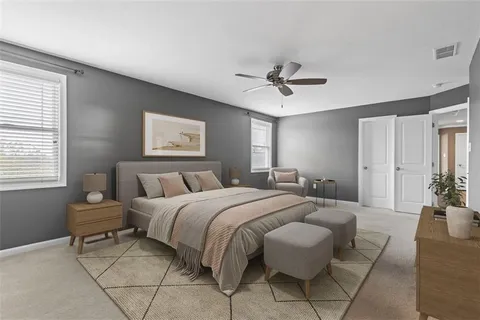 a spacious bedroom with a bed and a chandelier