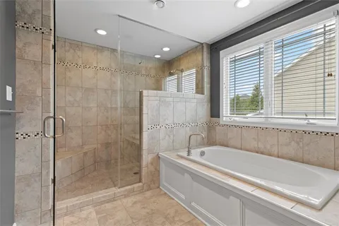 a bathroom with a bathtub and shower
