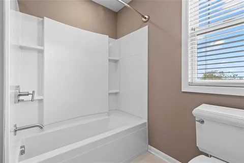a bathroom with a bathtub and a toilet