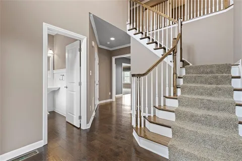 a view of entryway and hall with wooden floor