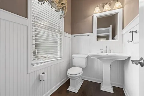 a bathroom with a sink a toilet and a mirror