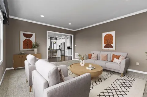 a living room with furniture and a rug