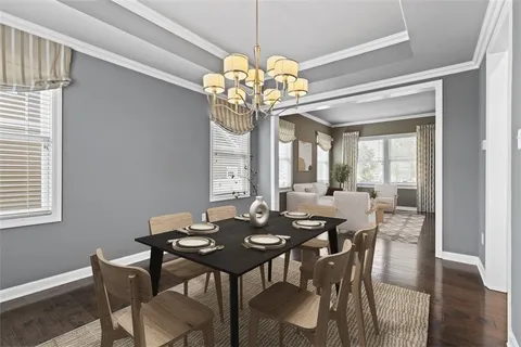 a view of a dining room with furniture a chandelier and wooden floor