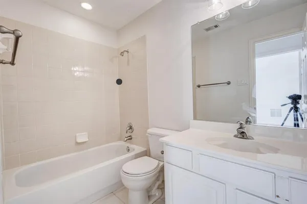 a bathroom with a sink a toilet and bathtub