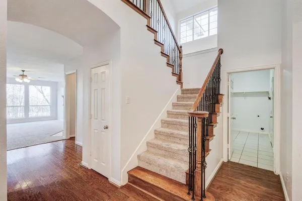 a view of entryway and hall with wooden floor