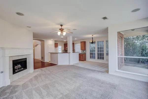 a view of a livingroom with a fireplace and window